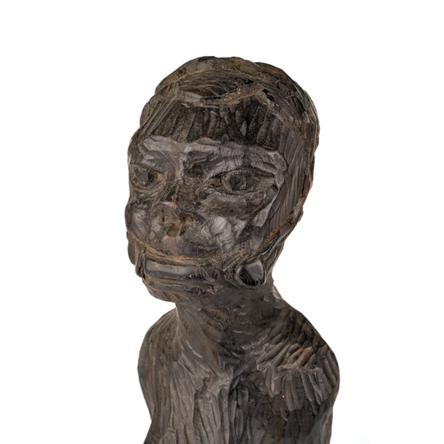 523 - An African carved wooden slave figure in chains and chocker , 37 cm.