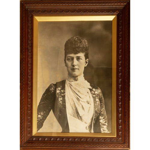 577 - A pair of large photographic portraits of King Edward VII and Queen Alexandra in carved wood frames,... 