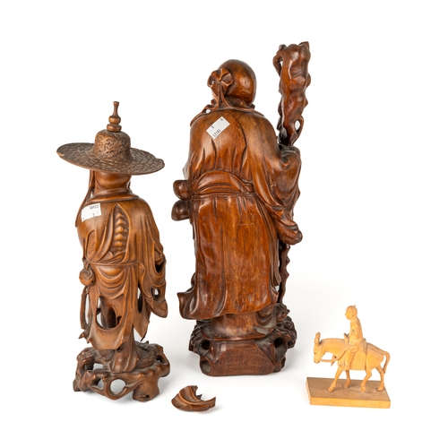 578 - Two Chinese carved hardwood Okimonos and a figure on a donkey (3). Tallest 41 cm tall