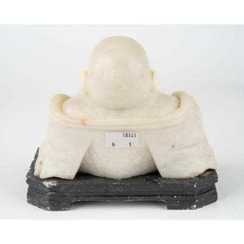 596 - A carved alabaster figure of the laughing Buddha, hotei, 15 cm tall.