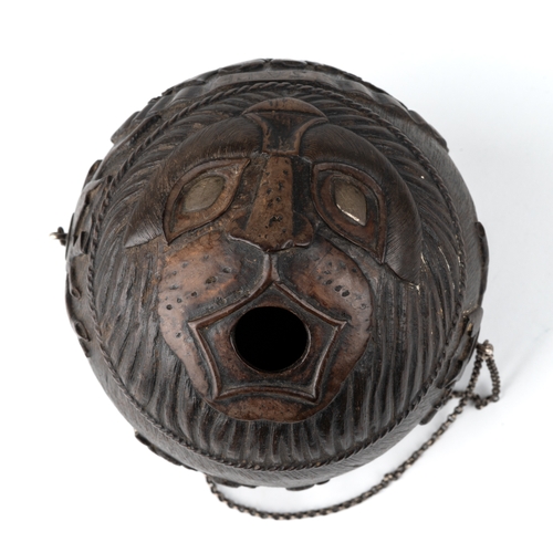 601 - An antique Georgian carved coconut bug bear powder flask, carved with various motifs including trees... 