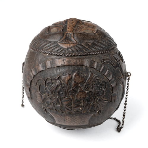 601 - An antique Georgian carved coconut bug bear powder flask, carved with various motifs including trees... 