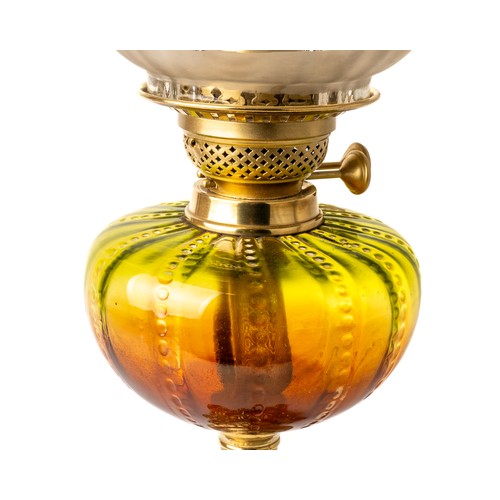 621 - A Victorian oil lamp with gilt metal base, brass fittings,  amber and green body and green etched sh... 