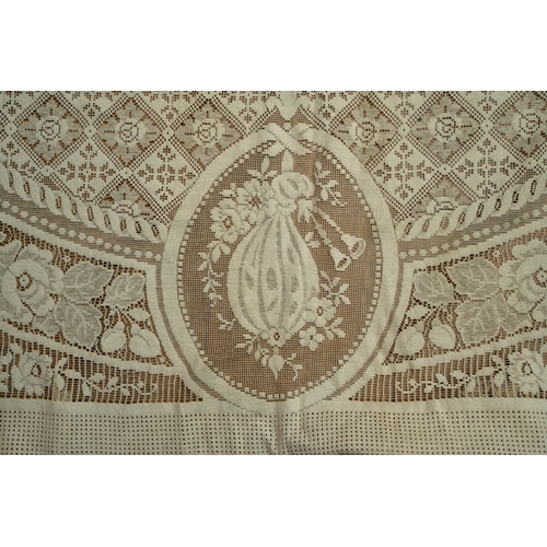 664 - A late 19th/early 20th Century lace bed spread /table cloth, the central section decorated with putt... 