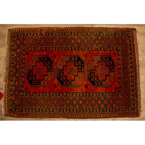 665 - An Afghan Old Gold rug with three 