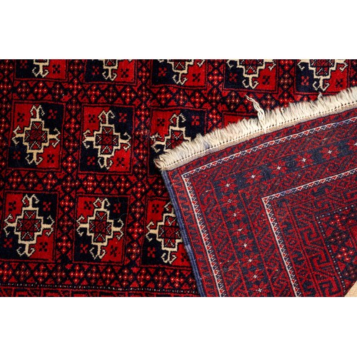 668 - A vintage Persian red rug with geometric pattern, approx 150cm x 100cm