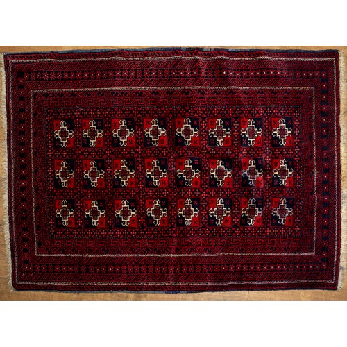 668 - A vintage Persian red rug with geometric pattern, approx 150cm x 100cm