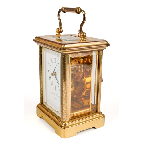 672 - A 20th century Swiss brass carriage clock by Matthew Norman, white enamel dial with Roman numerals, ... 