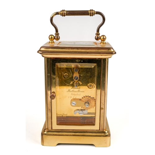 672 - A 20th century Swiss brass carriage clock by Matthew Norman, white enamel dial with Roman numerals, ... 