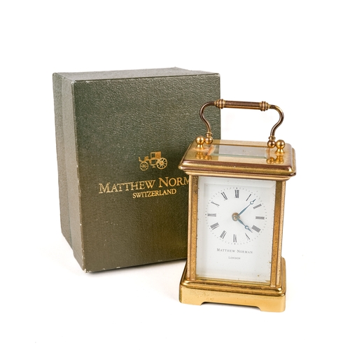 672 - A 20th century Swiss brass carriage clock by Matthew Norman, white enamel dial with Roman numerals, ... 