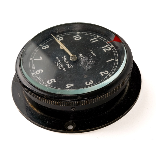 676 - A Smiths bezel wind car clock M1, black case, approx 7.3cm diameter