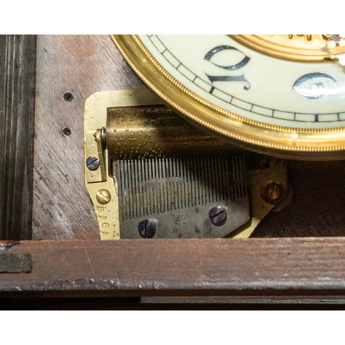 683 - A German springer wall clock with musical player, hourly disk comb player