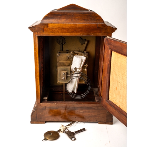 691 - An Edwardian bracket clock, in honey coloured oak, gilt metal detail to face, key to front and back ... 