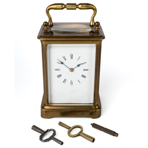 700 - A 19th century brass carriage clock, striking on a gong, with two keys, 13cm high without handle