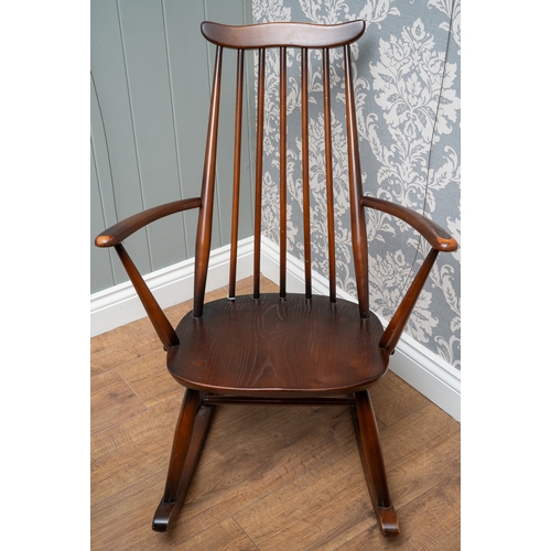 701 - An Ercol elm and beech Goldsmith rocking chair, 84 cm tall.