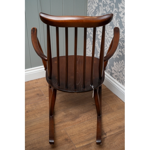 701 - An Ercol elm and beech Goldsmith rocking chair, 84 cm tall.