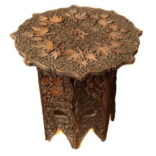 703 - Eastern carved hardwood  folding table, approx. 61 cm tall and diameter 66 cm.