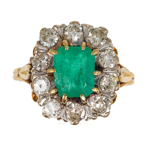 9 - An 18ct yellow gold emerald and diamond cluster ring, the step-cut emerald surrounded by ten round d... 