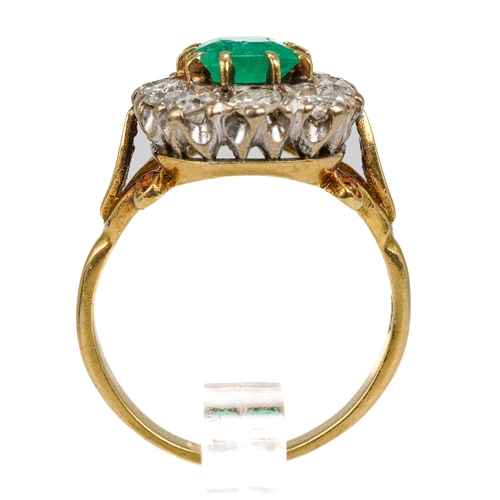 9 - An 18ct yellow gold emerald and diamond cluster ring, the step-cut emerald surrounded by ten round d... 