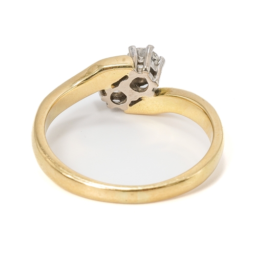 13 - An 18ct yellow gold and diamond two stone crossover ring, set with round brilliant cut diamonds, eac... 