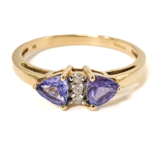 18 - A 9ct yellow gold tanzanite and diamond ring, two triangular-cut tanzanites centered with three smal... 