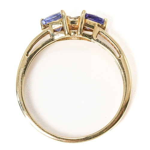 18 - A 9ct yellow gold tanzanite and diamond ring, two triangular-cut tanzanites centered with three smal... 