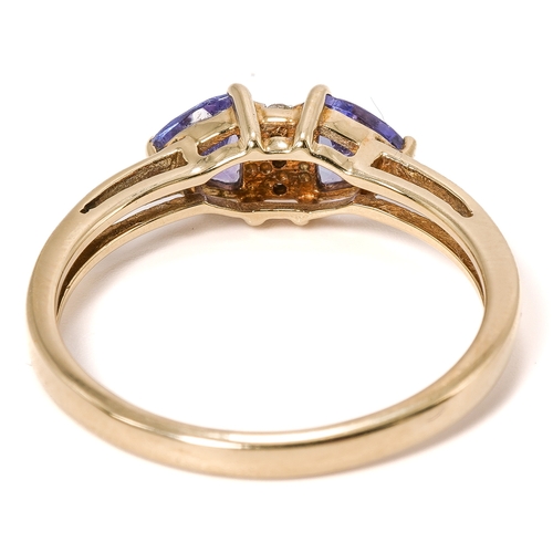 18 - A 9ct yellow gold tanzanite and diamond ring, two triangular-cut tanzanites centered with three smal... 