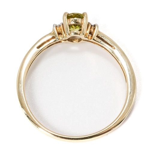 19 - A 9ct yellow gold peridot and diamond ring, the oval mixed-cut peridot approx 6mm x 4mm, size N1/2, ... 