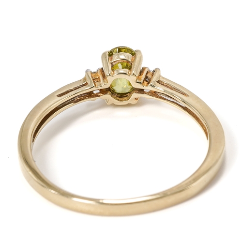 19 - A 9ct yellow gold peridot and diamond ring, the oval mixed-cut peridot approx 6mm x 4mm, size N1/2, ... 