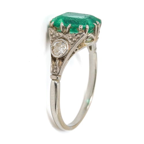 25 - An Art Deco platinum emerald and diamond ring, the emerald approx 9mm x 7mm x 4.4mm, two old-cut dia... 