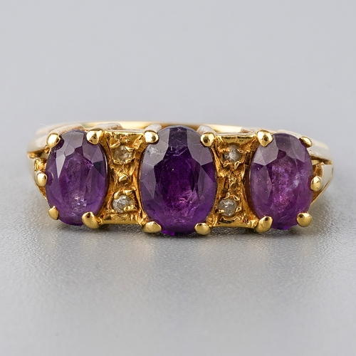 30 - An 18ct yellow gold and amethyst three-stone ring, set with three oval mixed-cut amethyst, diamond c... 