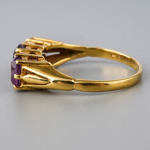 30 - An 18ct yellow gold and amethyst three-stone ring, set with three oval mixed-cut amethyst, diamond c... 