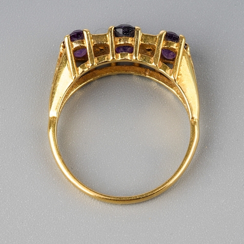 30 - An 18ct yellow gold and amethyst three-stone ring, set with three oval mixed-cut amethyst, diamond c... 