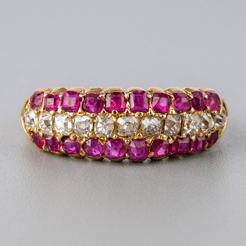 31 - A yellow gold ruby and diamond ring, set with old-cut diamonds flanked by two rows of mixed-cut rubi... 