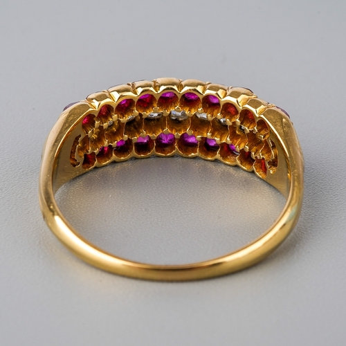 31 - A yellow gold ruby and diamond ring, set with old-cut diamonds flanked by two rows of mixed-cut rubi... 