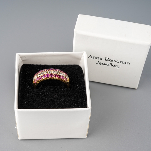 31 - A yellow gold ruby and diamond ring, set with old-cut diamonds flanked by two rows of mixed-cut rubi... 