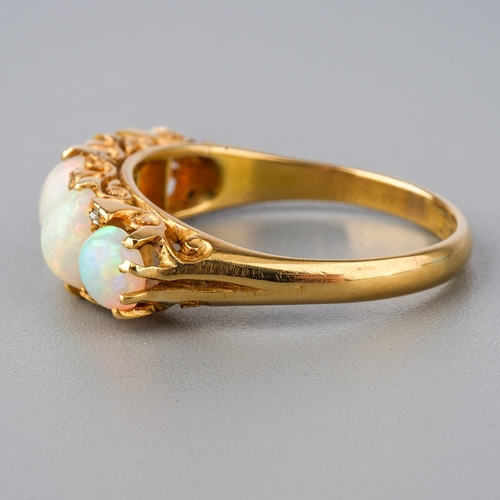 32 - An 18ct yellow gold opal five-stone ring, set with graduated cabochon opals, diamond highlights, siz... 