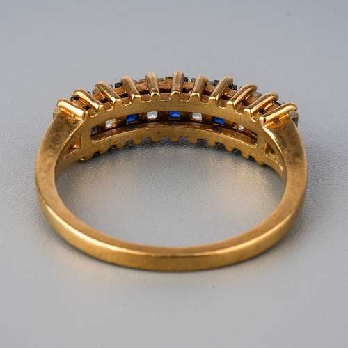 33 - A 9ct yellow gold ring, set with alternating blue and white stones possibly spinel, size O, total gr... 