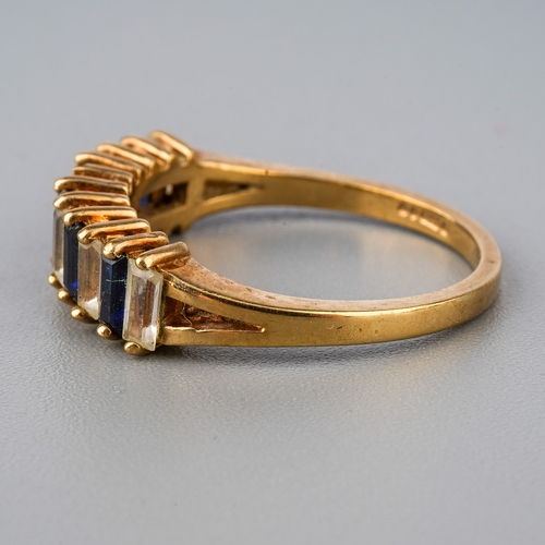 33 - A 9ct yellow gold ring, set with alternating blue and white stones possibly spinel, size O, total gr... 