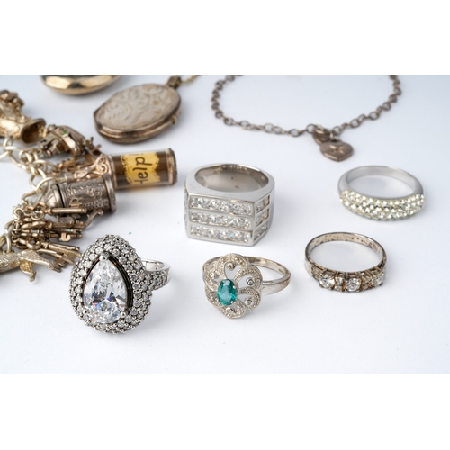 44 - A collection of silver jewellery, to include a charm bracelet, lockets, chain, CZ set rings and earr... 