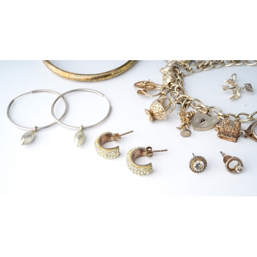 44 - A collection of silver jewellery, to include a charm bracelet, lockets, chain, CZ set rings and earr... 