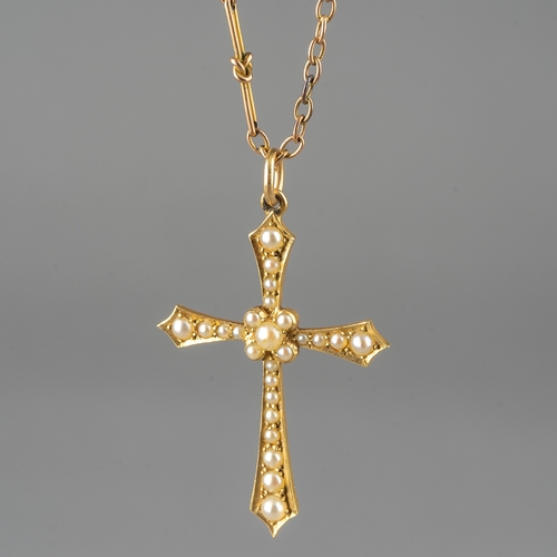 56 - A 15ct yellow gold and seed pearl cross pendant, stamped '15', on a 9ct yellow gold fancy link chain... 