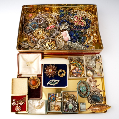 62 - A large quantity of costume jewellery including a Butler and Wilson style swan brooch; Hollywood bro... 