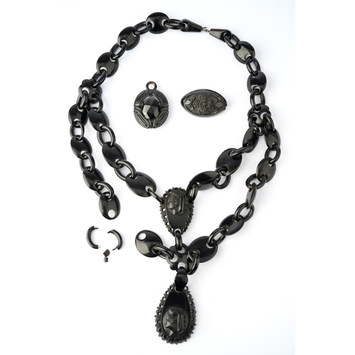 63 - A Victorian jet necklace, having two carved panels depicting the profile of classical ladies, suspen... 