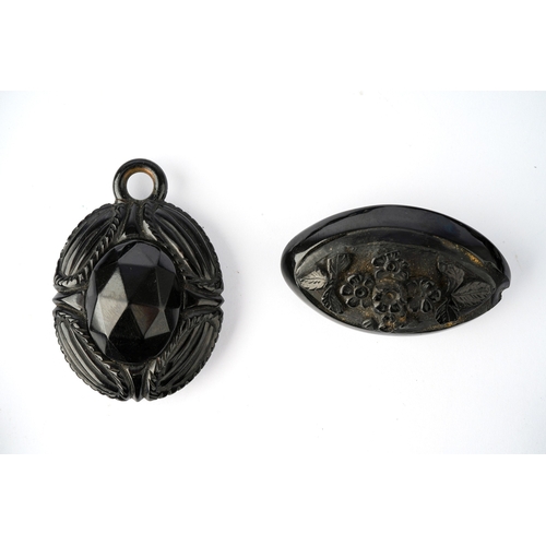 63 - A Victorian jet necklace, having two carved panels depicting the profile of classical ladies, suspen... 