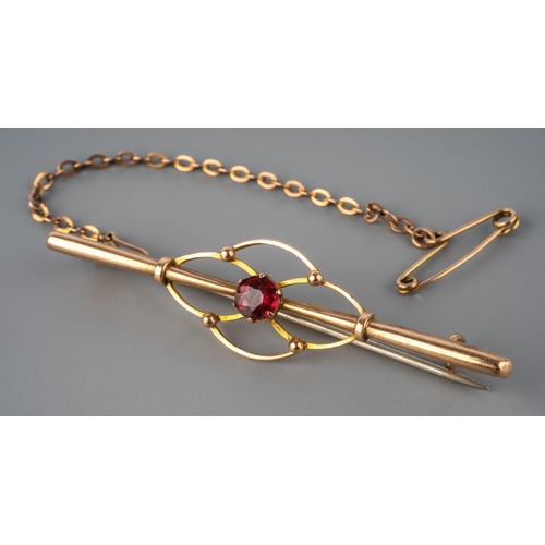 68 - An Edwardian 9ct yellow gold bar brooch, set with a ruby, steel hinged pin, total gross weight appro... 