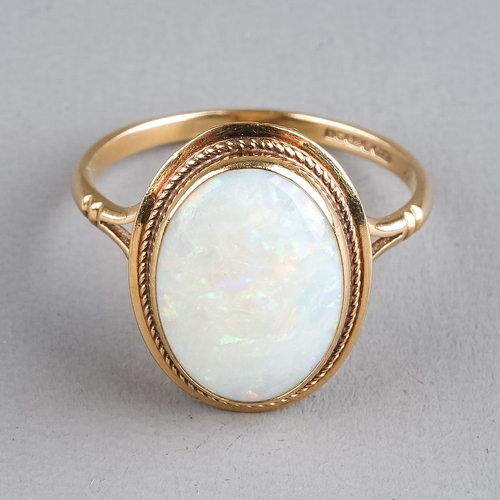 73 - A 9ct yellow gold opal ring, set with an oval cabochon stone, ring size O, total gross weight approx... 