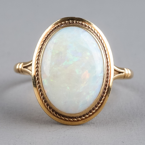 73 - A 9ct yellow gold opal ring, set with an oval cabochon stone, ring size O, total gross weight approx... 