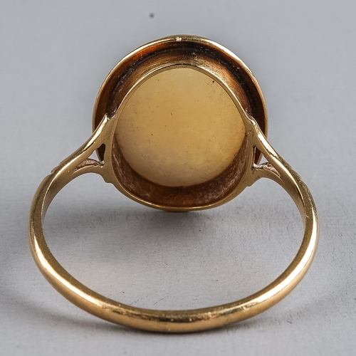 73 - A 9ct yellow gold opal ring, set with an oval cabochon stone, ring size O, total gross weight approx... 