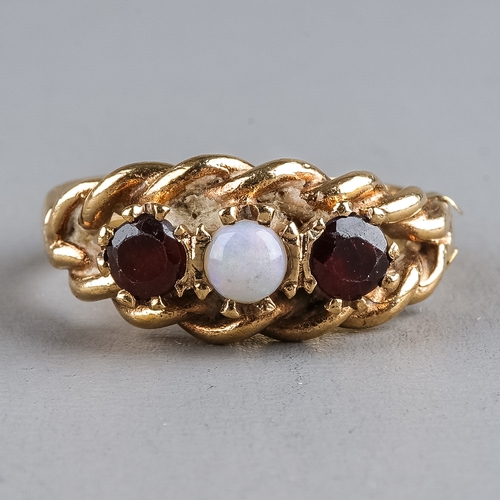 77 - A 9ct yellow gold opal and garnet ring, set with one round cabochon opal flanked by two round-cut ga... 